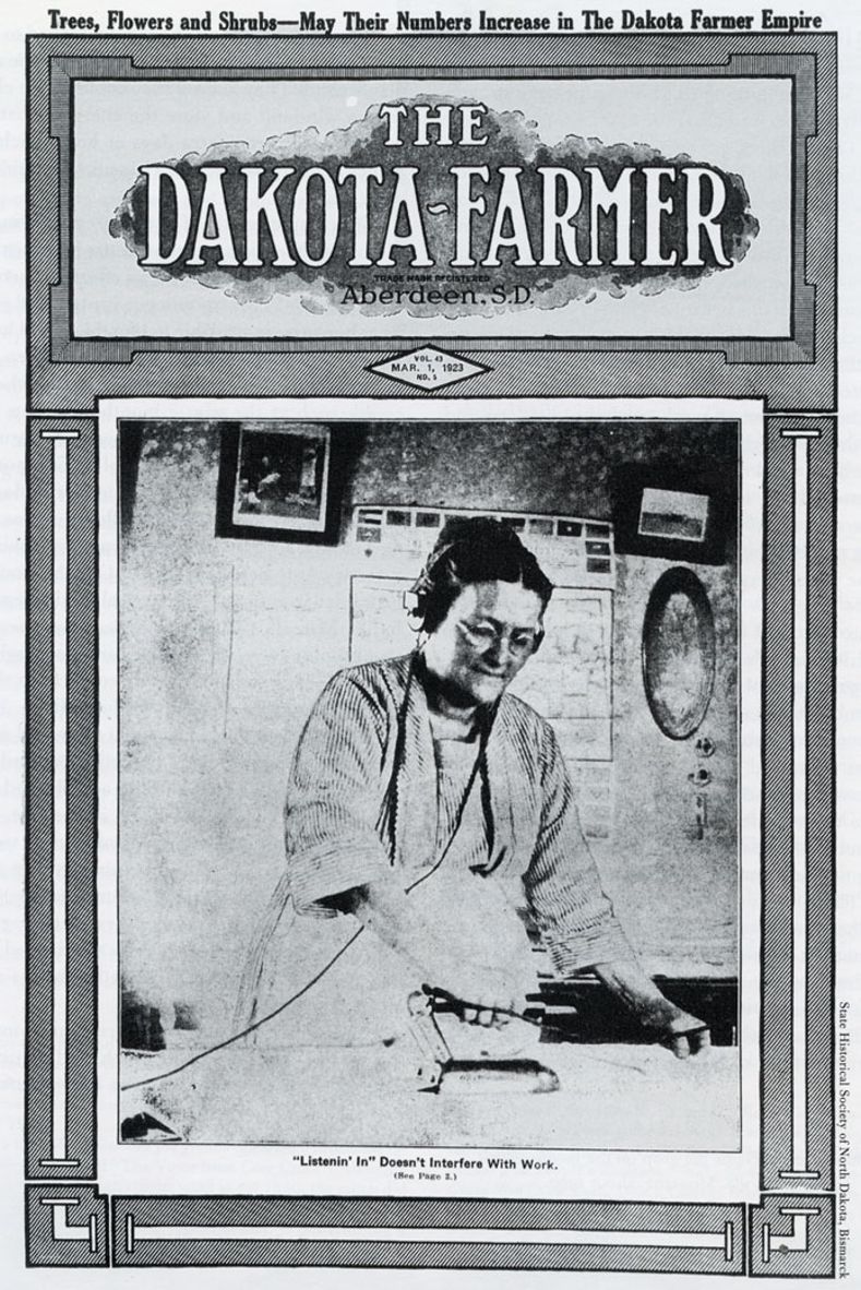 The cover of the March, 1923 issue of the Dakota Farmer: Pictured is Ida Jacobs using an electric iron and listening to the radio on the Jacobs ranch. 1923 Cover of Dakota Farmer